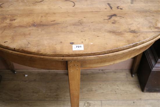 A French fruitwood demi lune fold out dining table, 124cm.